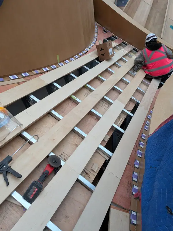 Curved stair millwork installation in progress