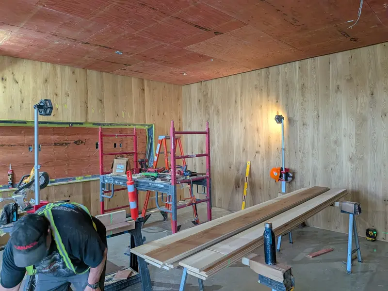 Wood wall panel and millwork installation in progress
